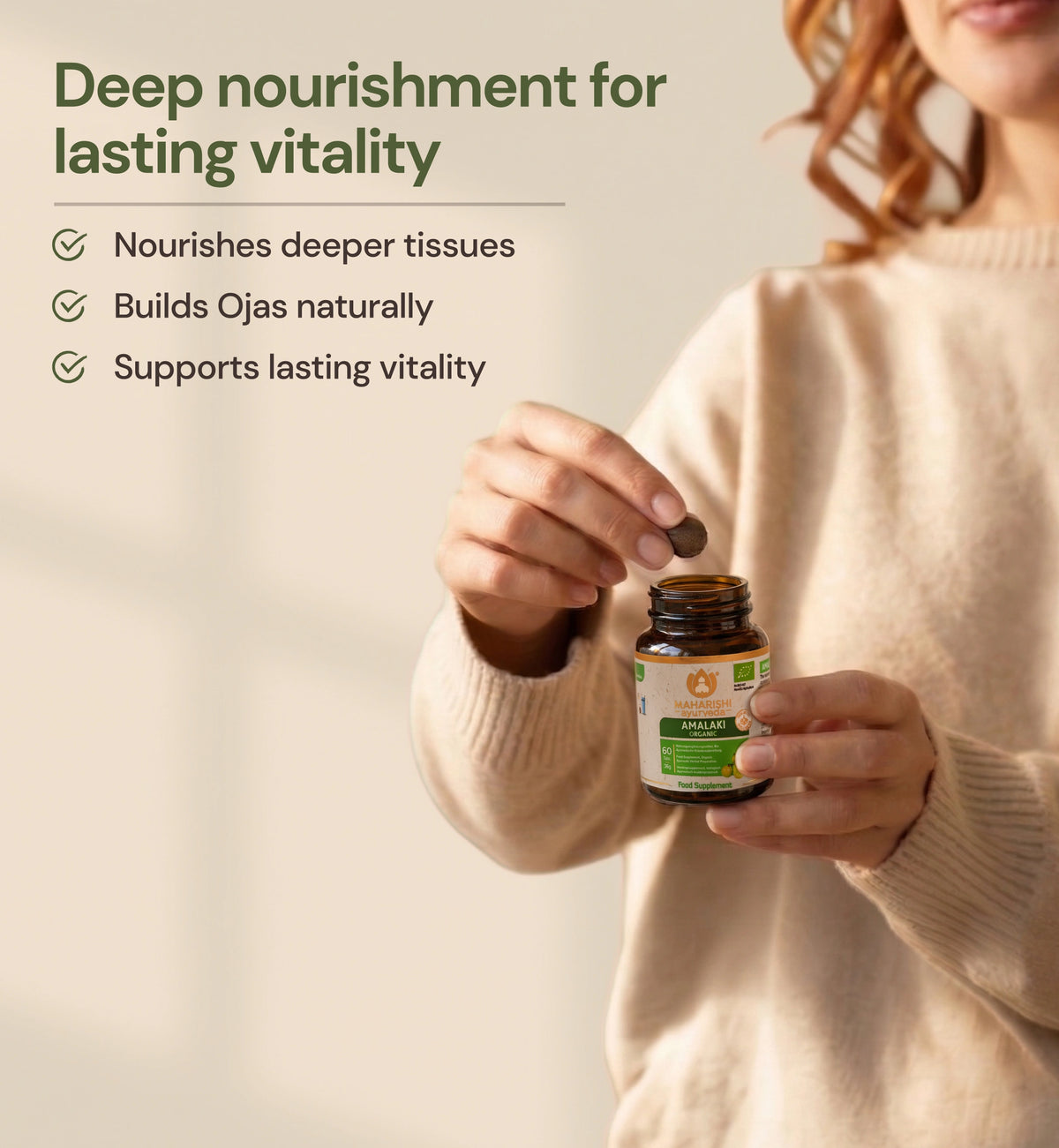 Woman taking an Amalaki Organic tablet for daily vitality